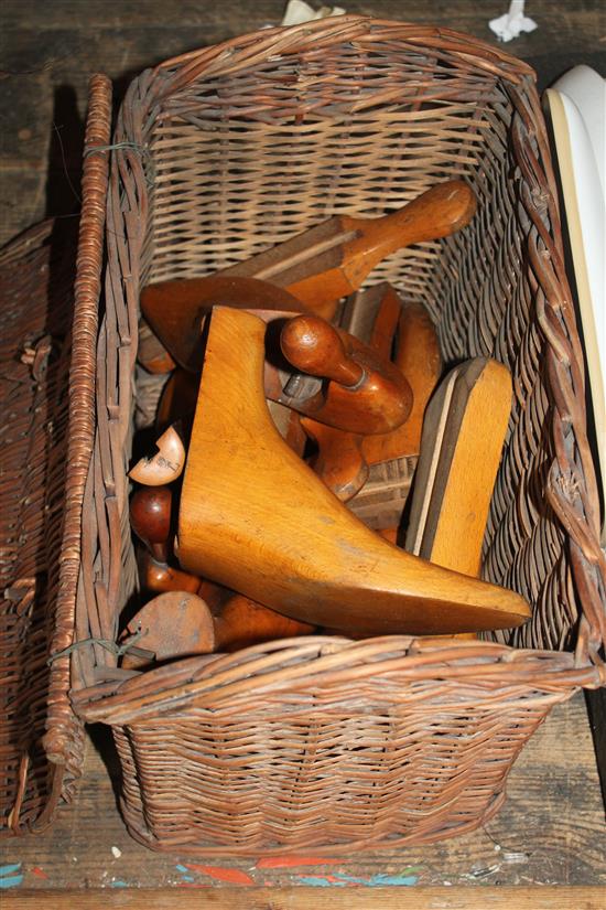 Collection of shoe lasts and a wicker basket